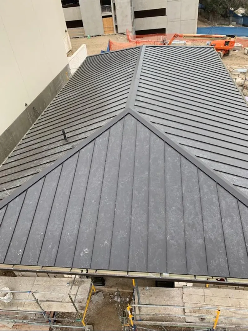 Commercial metal roof construction with crane equipment in Galion