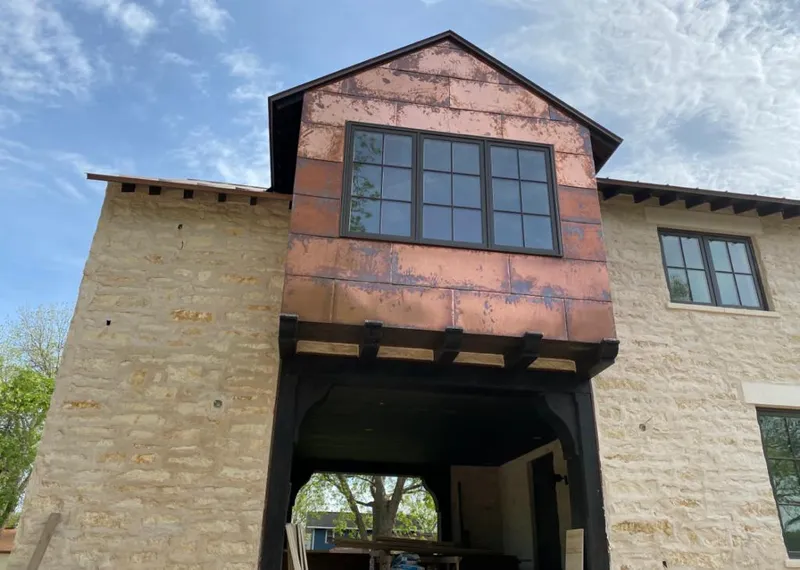 Copper metal panel facade on a stone building for Skylight Installation in Galion